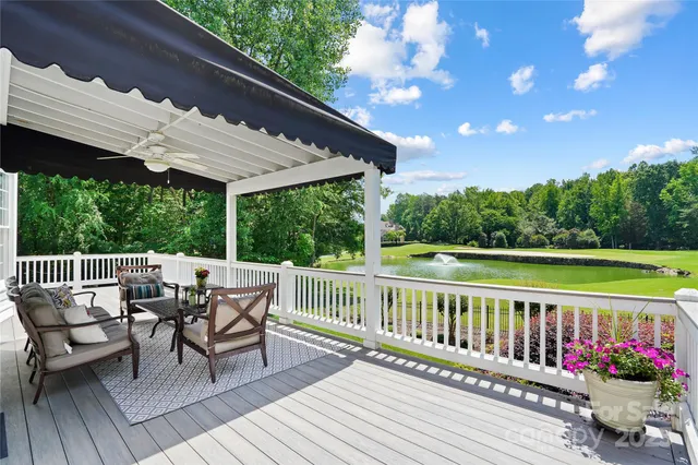 a view of a chairs and table on the roof deck