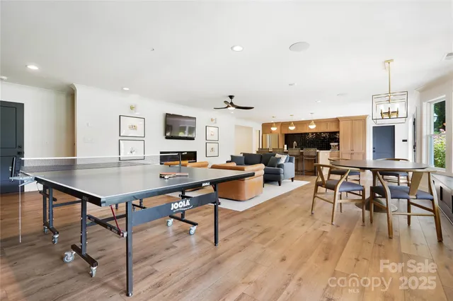 a living room with dining room and wooden floor