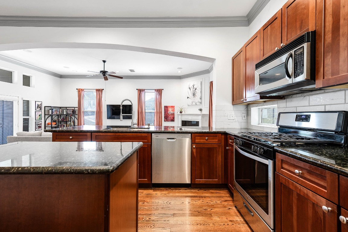 5723 Petty Street Houston, TX 77007 - Photo 14 of 31 a kitchen with stainless steel appliances granite countertop a stove a sink and a microwave