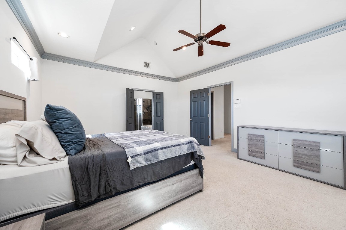 5723 Petty Street Houston, TX 77007 - Photo 28 of 31 a spacious bedroom with a bed and a chandelier