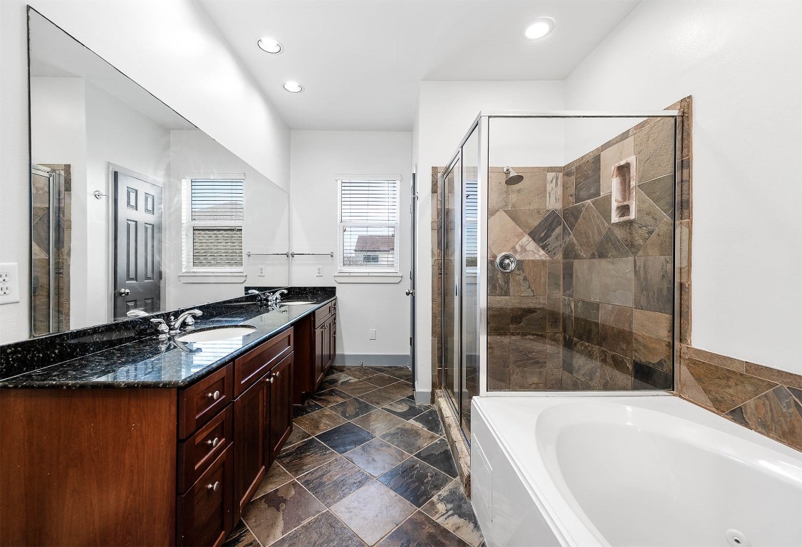 5723 Petty Street Houston, TX 77007 - Photo 29 of 31 a large bathroom with a granite countertop tub sink shower and mirror