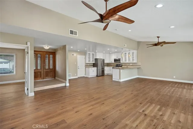 a kitchen with kitchen island granite countertop appliances cabinets and a counter space