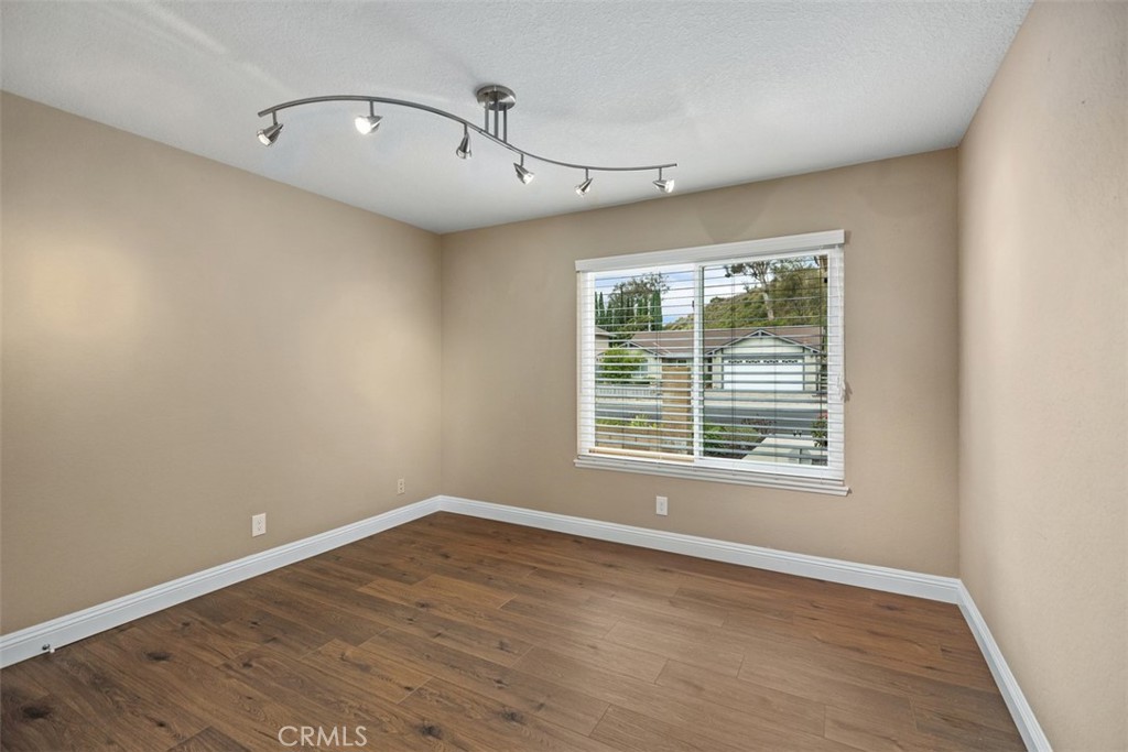 22182 Platino Mission Viejo, CA 92691 - Photo 6 of 18 an empty room with wooden floor and windows