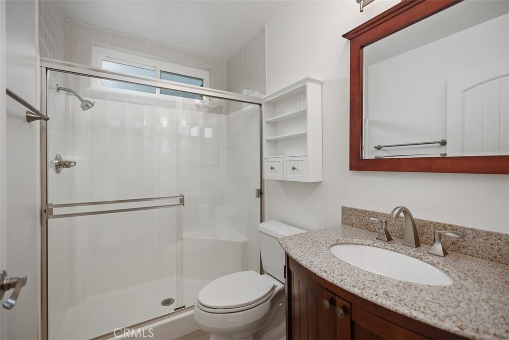 22182 Platino Mission Viejo, CA 92691 - Photo 9 of 18 a bathroom with a granite countertop sink toilet mirror and shower