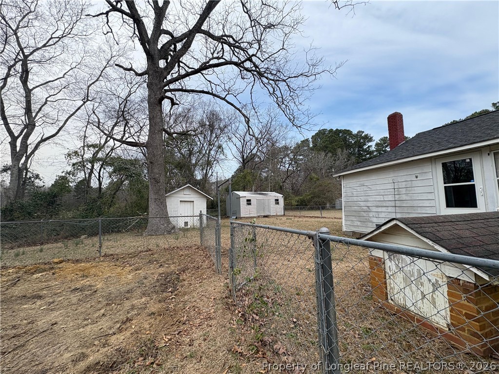 3174 Lindsay Road Raeford, NC 28376 - Photo 27 of 28 a backyard of a house with table and chairs