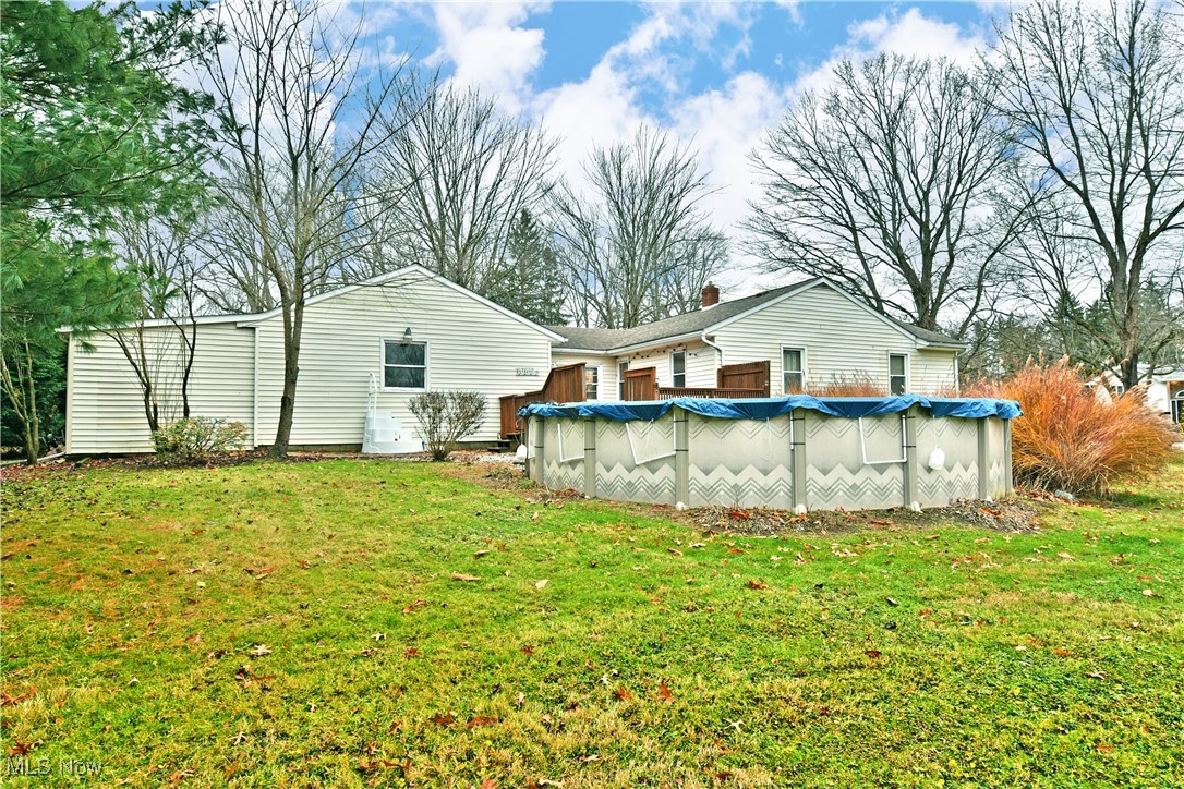 3224 Reeves Road Northeast Warren, OH 44483 - Photo 43 of 49 Rear view of house with a covered pool and a lawn