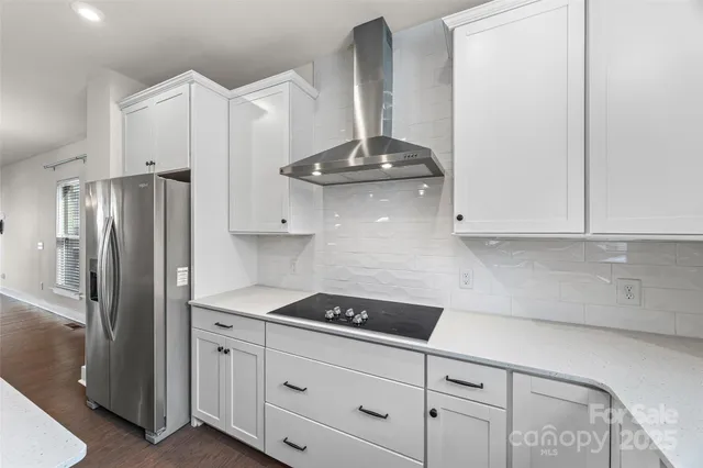 a kitchen with stainless steel appliances a sink stove and refrigerator