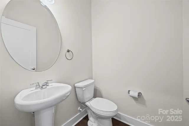 a bathroom with a sink toilet and a mirror
