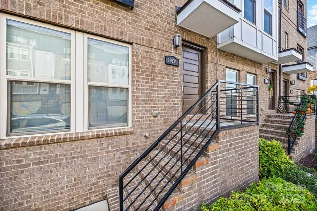 a view of a brick house with a large window