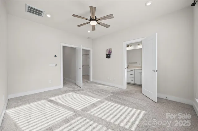 a view of a livingroom with a space & a ceiling fan