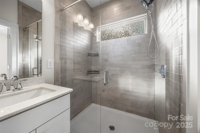 a bathroom with a sink and shower