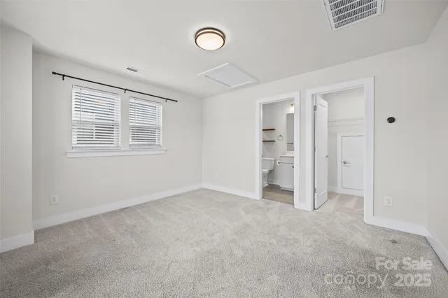 an empty room with a window and a fireplace