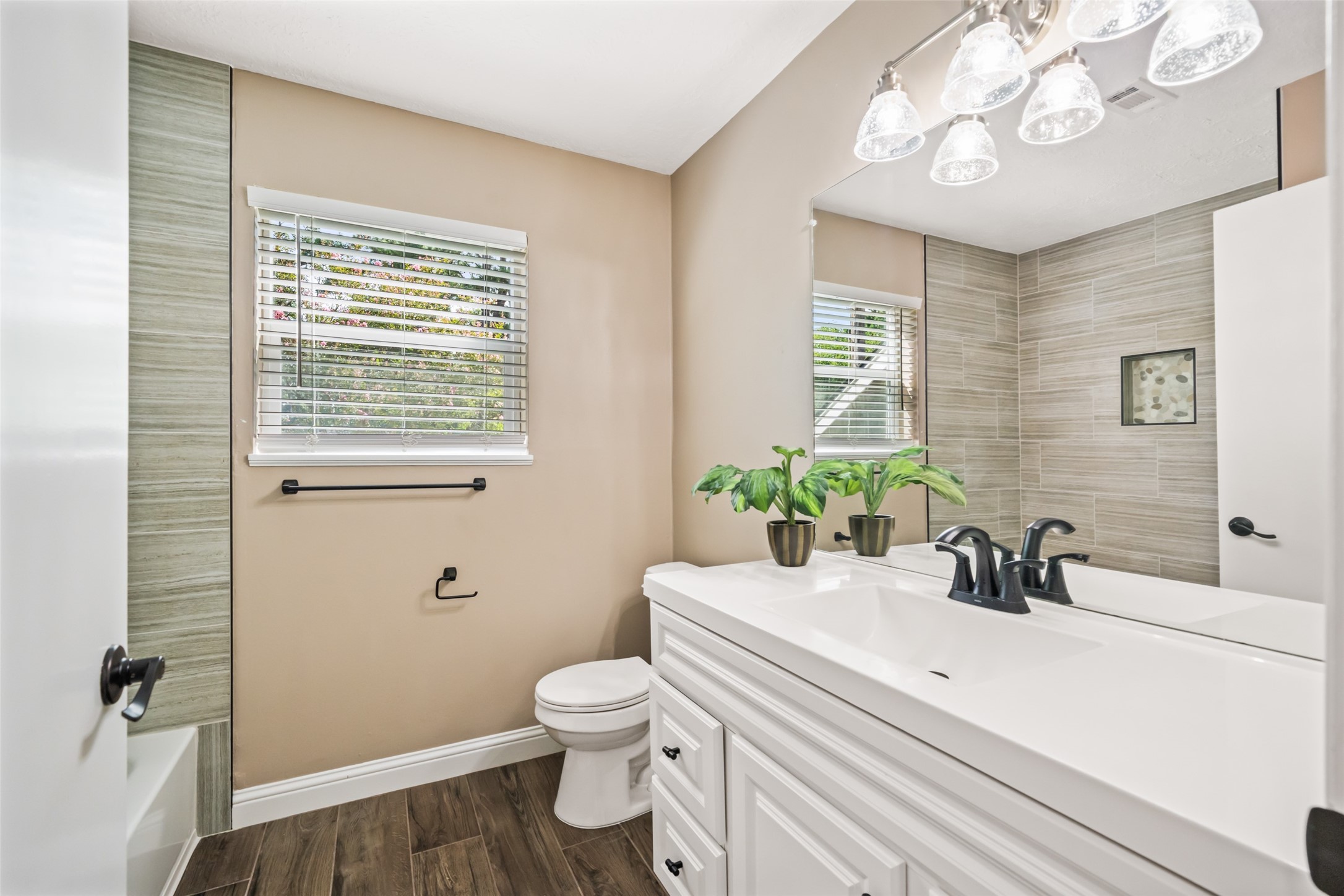 3019 Ramblewood Road Montgomery, TX 77356 - Photo 32 of 40 a bathroom with a sink a toilet and a mirror