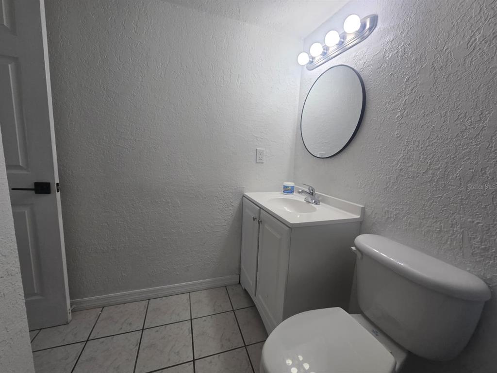 902 Lake Destiny Road, Unit C Altamonte Springs, FL 32714 - Photo 11 of 23 a bathroom with a toilet a sink and a mirror