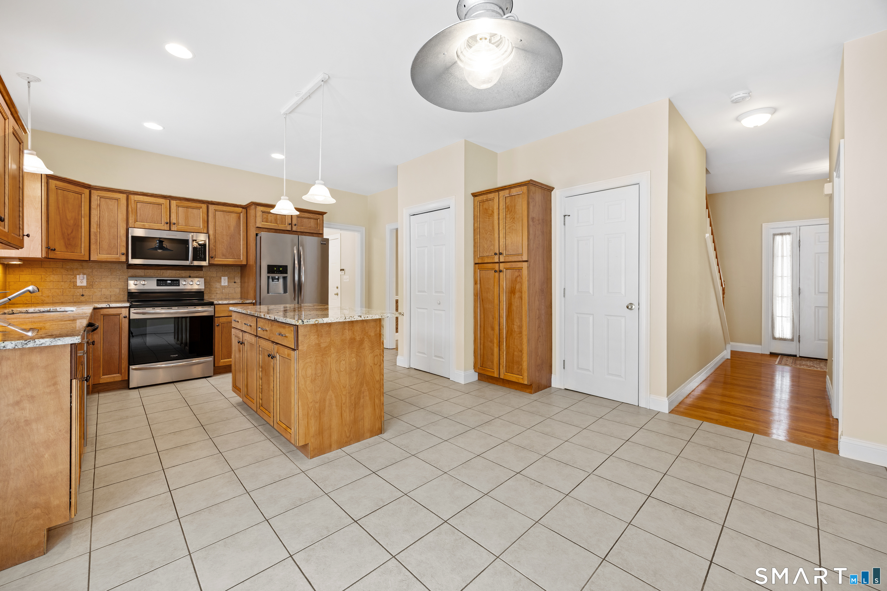 11 Nature Trail Hamden, CT 06518 - Photo 7 of 28 a kitchen with stainless steel appliances granite countertop a refrigerator and a stove top oven