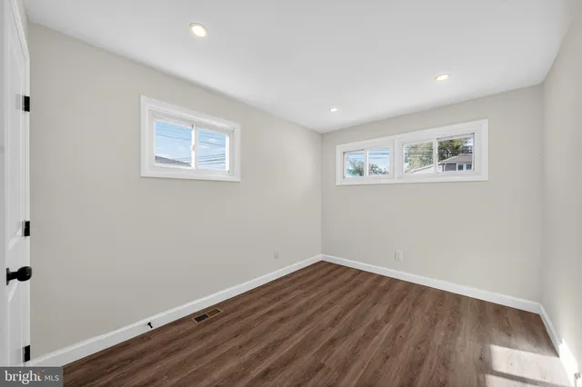 a view of a room with wooden floor and window
