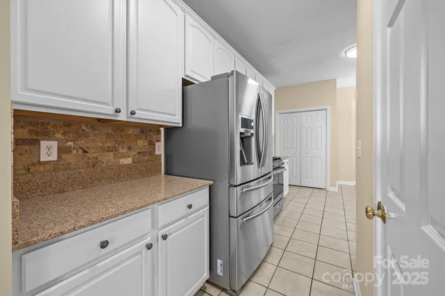 a kitchen with cabinets and stainless steel appliances