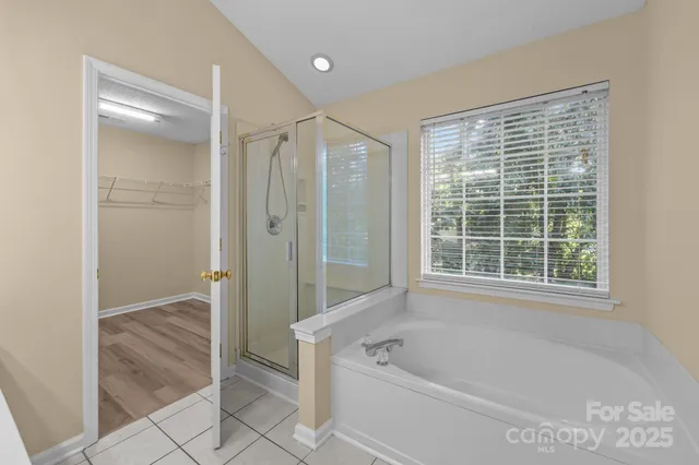 a bathroom with a bathtub and shower