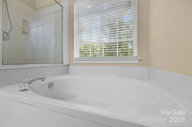 a white bath tub sitting next to a window