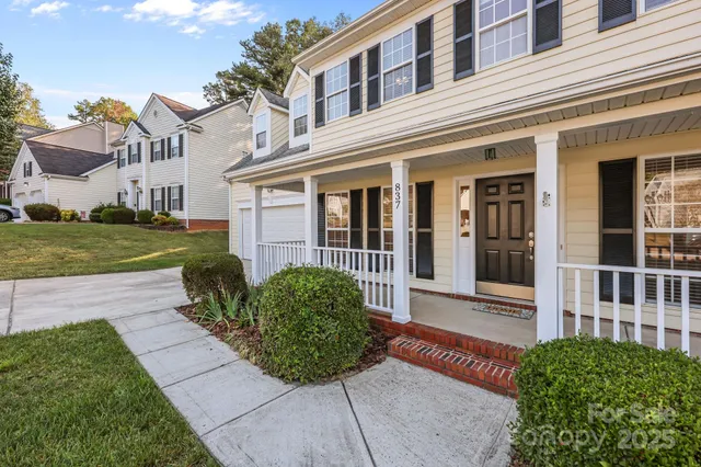 front view of a brick house with a yard