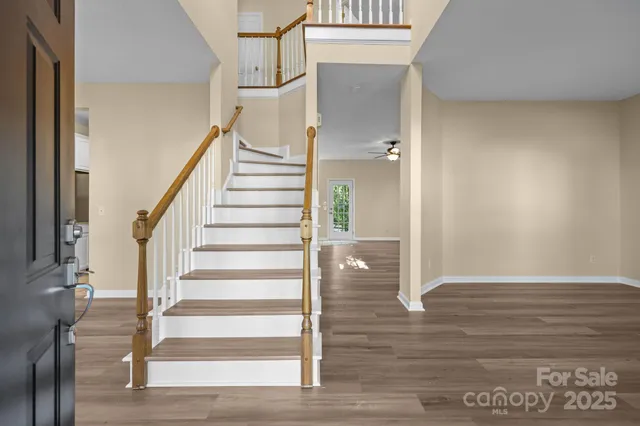 a view of entryway and hall with wooden floor