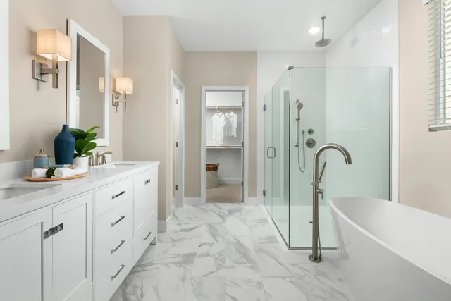 a spacious bathroom with a double vanity sink a mirror and a bathtub