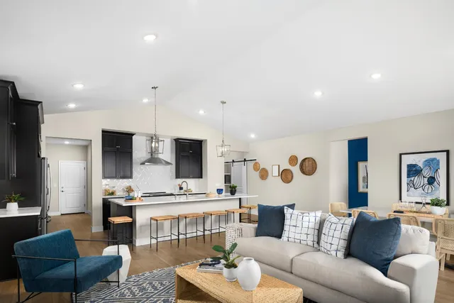 a living room with furniture and kitchen view