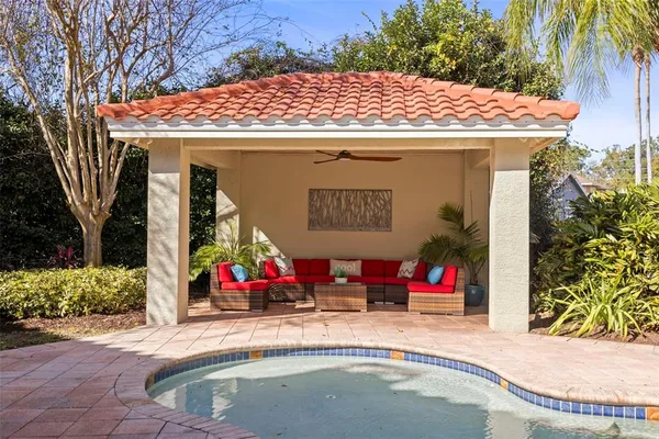 a view of a patio with table and chairs potted plants with wooden floor and fence
