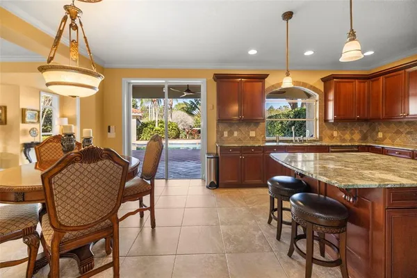 a dining room with furniture and a kitchen view