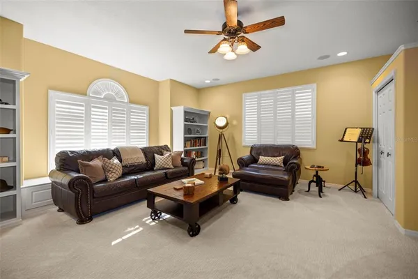 a dining room with furniture a chandelier and window