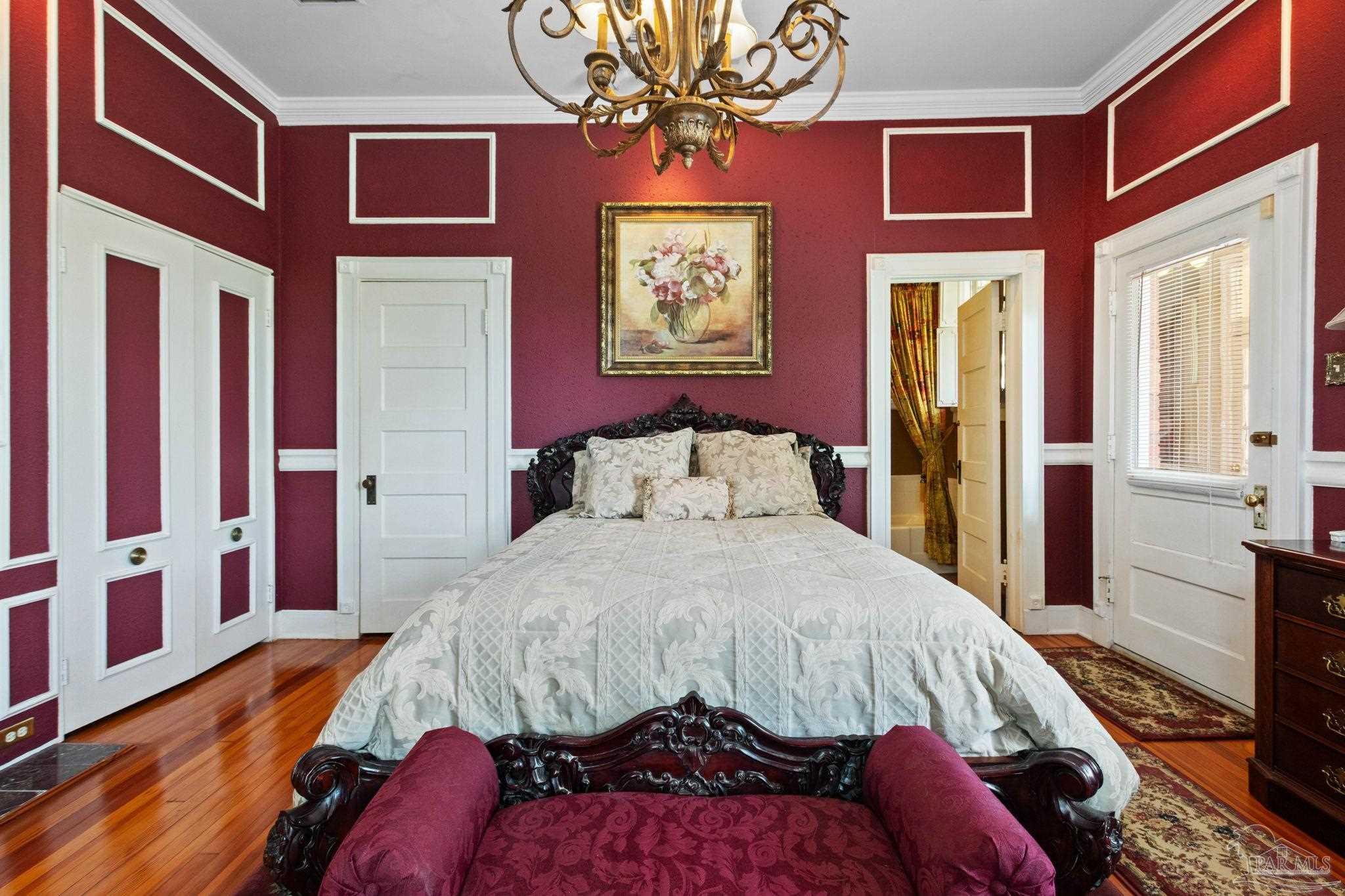 1701 Sowell Road Brewton, AL 36426 - Photo 55 of 72 a bedroom with a bed and a chandelier