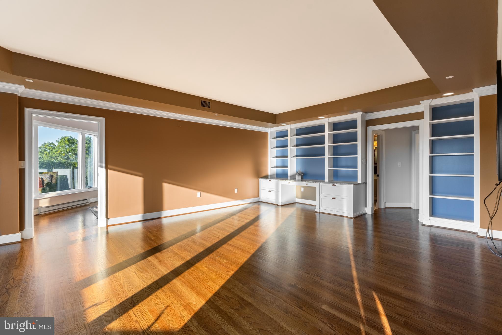 425 Windmere Drive, Unit 3B State College, PA 16801 - Photo 27 of 42 a view of empty room with wooden floor and windows