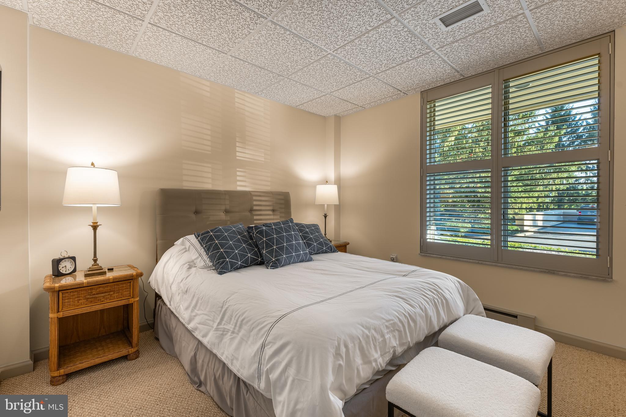 425 Windmere Drive, Unit 3B State College, PA 16801 - Photo 38 of 42 a bedroom with a bed and a lamp