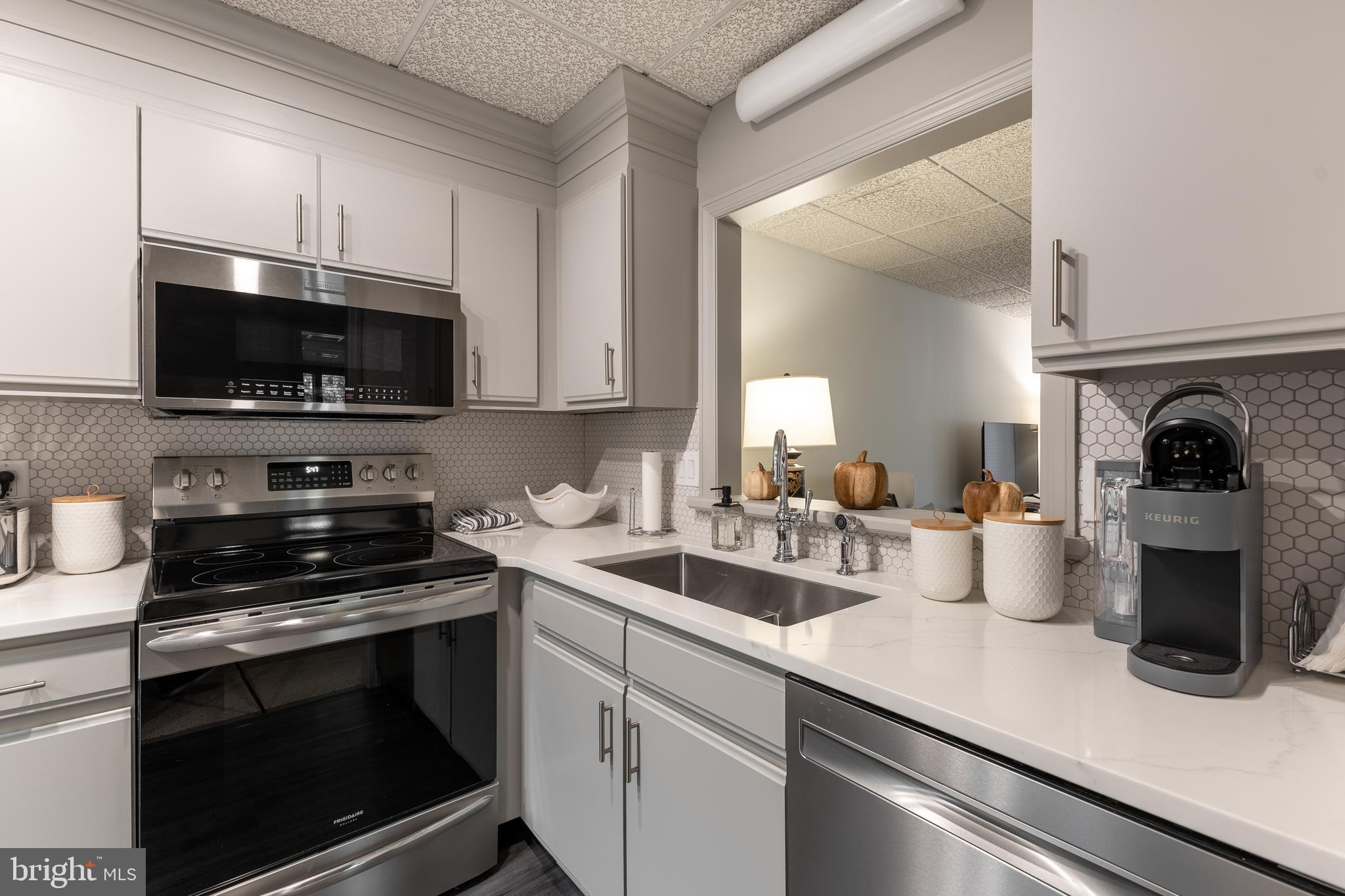 425 Windmere Drive, Unit 3B State College, PA 16801 - Photo 39 of 42 a kitchen with a sink a stove and microwave