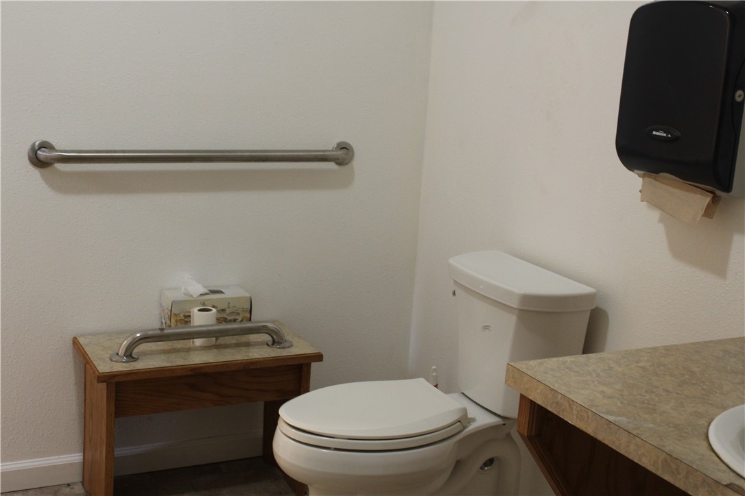 125 Lagarto Ferry Mathis, TX 78368 - Photo 14 of 38 a bathroom with a granite countertop toilet and a sink