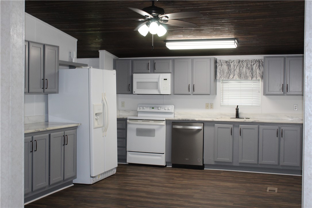 125 Lagarto Ferry Mathis, TX 78368 - Photo 2 of 38 a kitchen with a refrigerator sink and cabinets