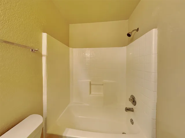 a bathroom with a shower and a toilet
