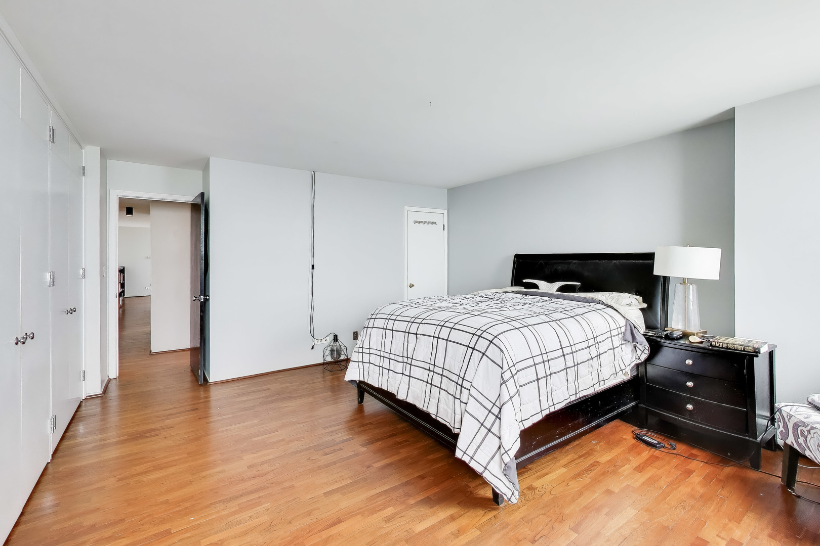 6325 North Sheridan Road, Unit 1602 Chicago, IL 60660 - Photo 16 of 38 a bedroom with a bed and wooden floor