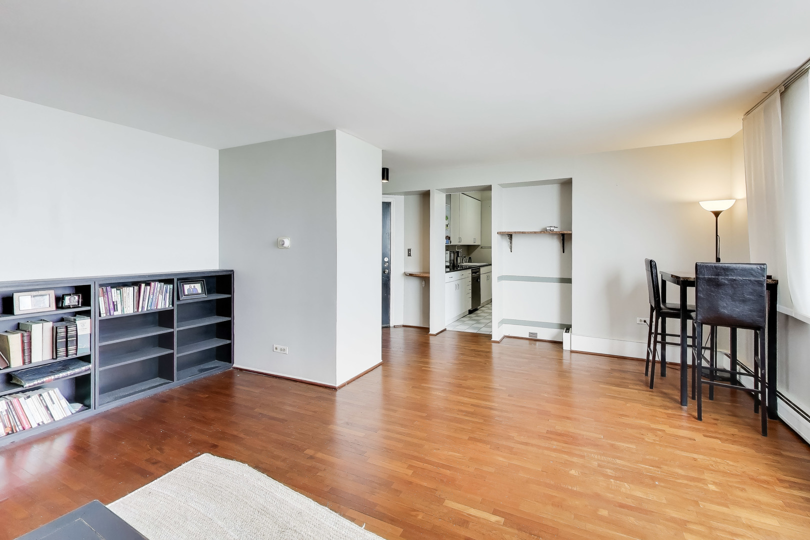 6325 North Sheridan Road, Unit 1602 Chicago, IL 60660 - Photo 6 of 38 a view of a kitchen with furniture and wooden floor