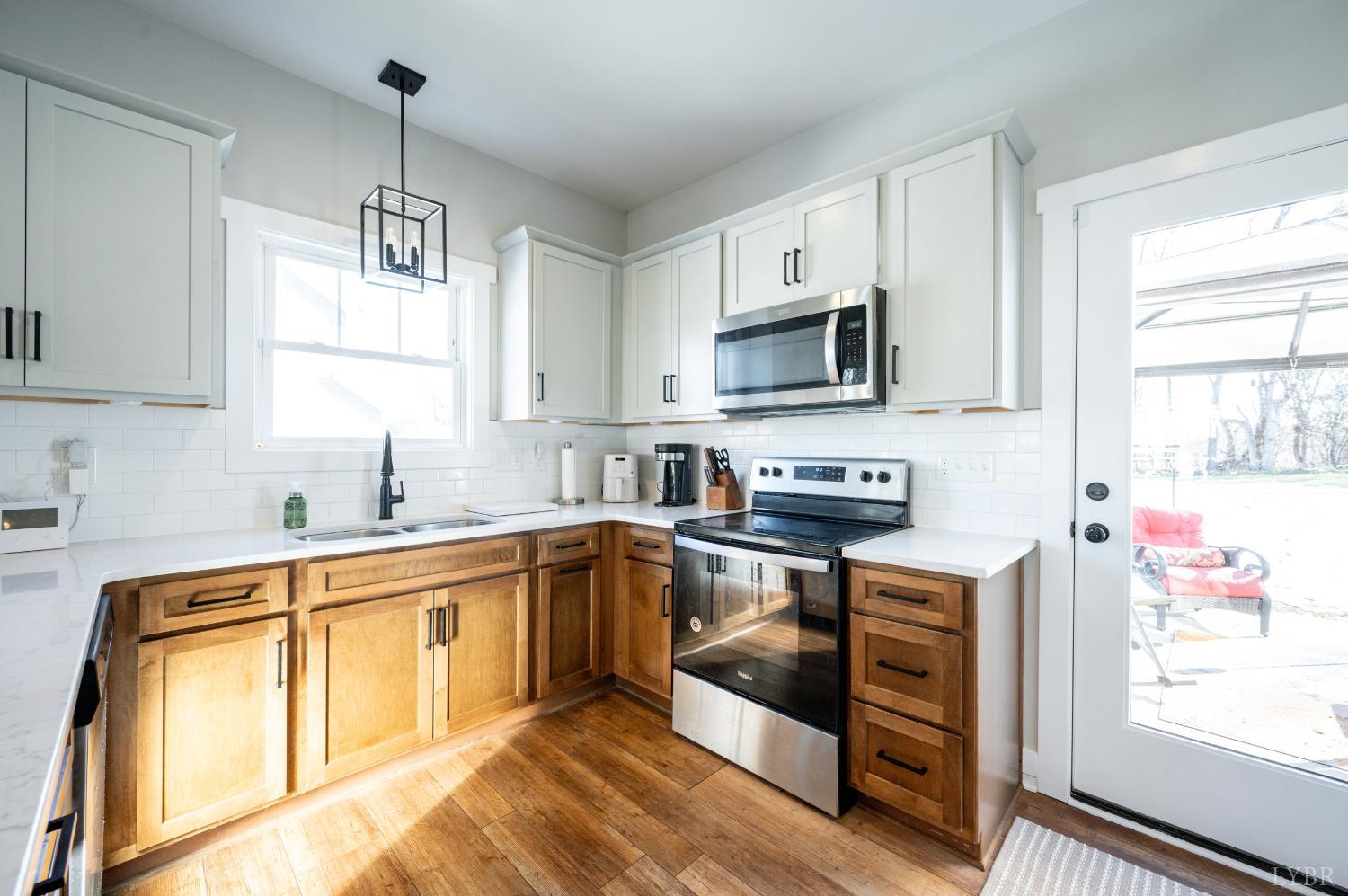 180 Timber Ridge Drive Forest, VA 24551 - Photo 12 of 58 a kitchen with stainless steel appliances granite countertop a sink stove and refrigerator
