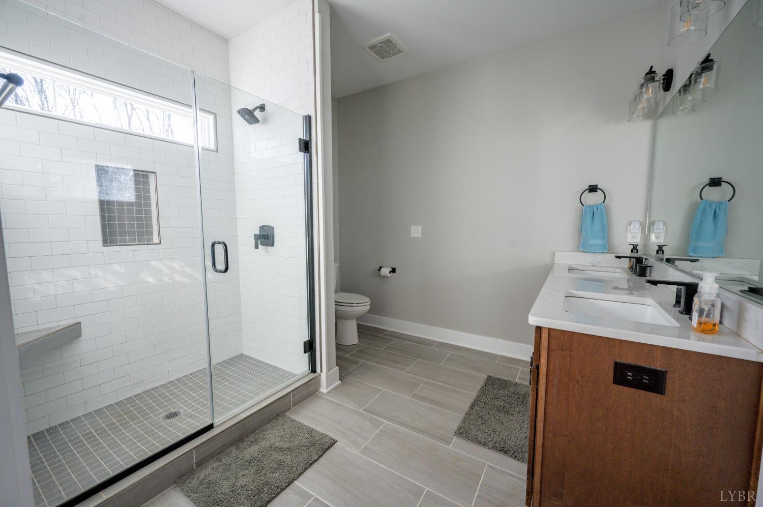 180 Timber Ridge Drive Forest, VA 24551 - Photo 21 of 58 a bathroom with a sink toilet and shower