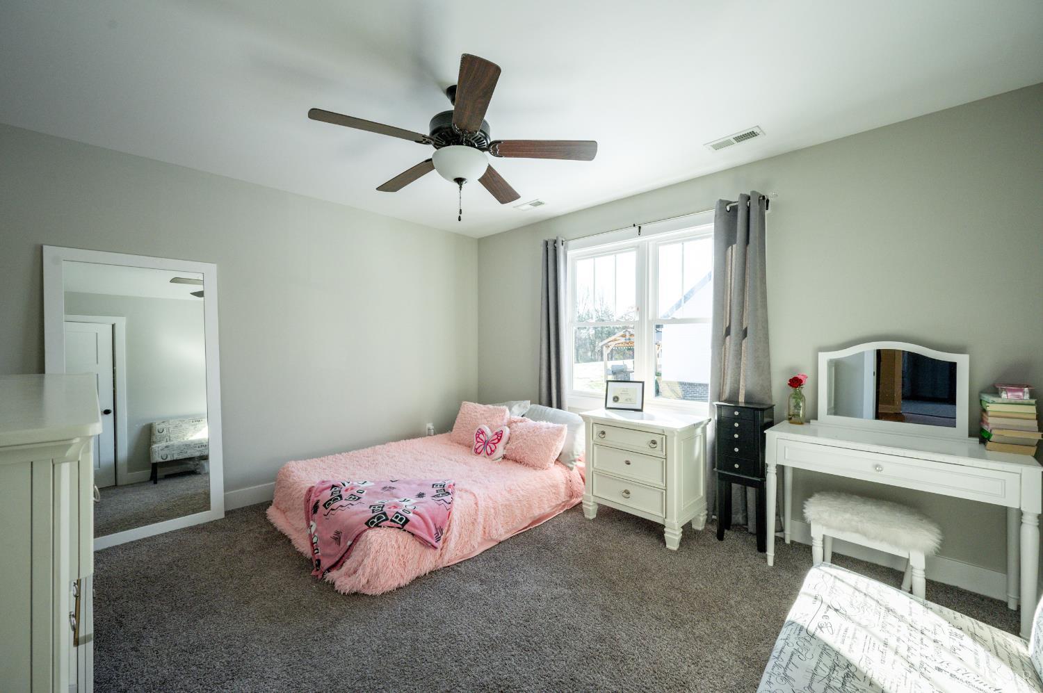 180 Timber Ridge Drive Forest, VA 24551 - Photo 32 of 58 a bedroom with a bed and a chandelier