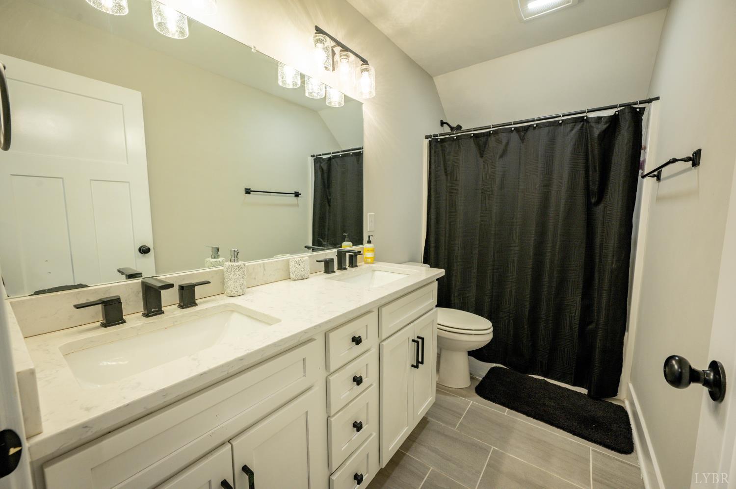 180 Timber Ridge Drive Forest, VA 24551 - Photo 35 of 58 a bathroom with a double vanity sink and mirror