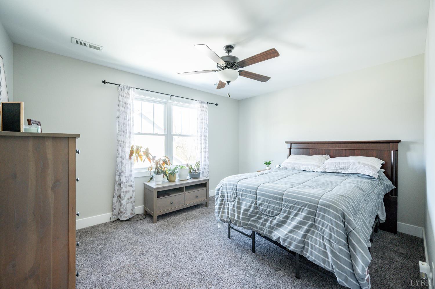 180 Timber Ridge Drive Forest, VA 24551 - Photo 38 of 58 a bedroom with a bed and a window