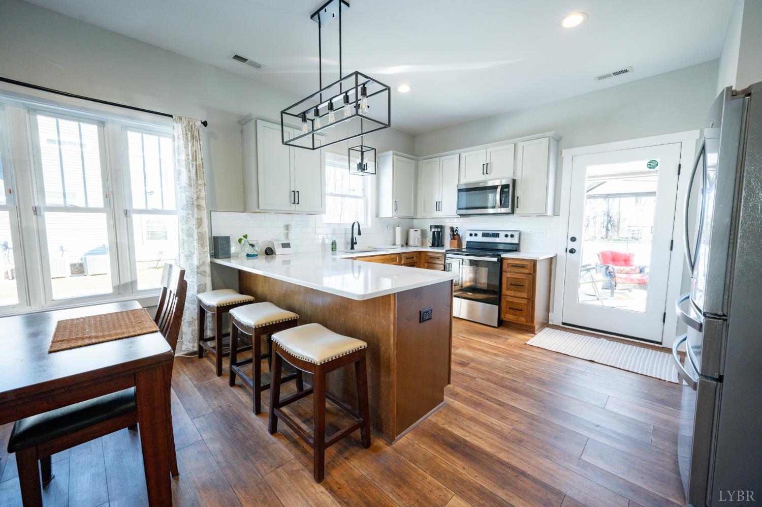 180 Timber Ridge Drive Forest, VA 24551 - Photo 10 of 58 a very nice looking kitchen with granite countertop a stove a sink a refrigerator dining table and chairs