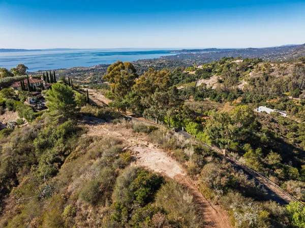 aerial view of a house with a yard and sitting space