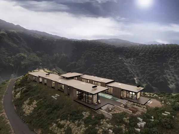 a front view of a house with a yard and mountain view in back