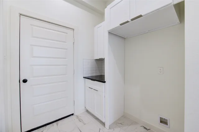 a kitchen with stainless steel appliances granite countertop a sink a stove a microwave and cabinets