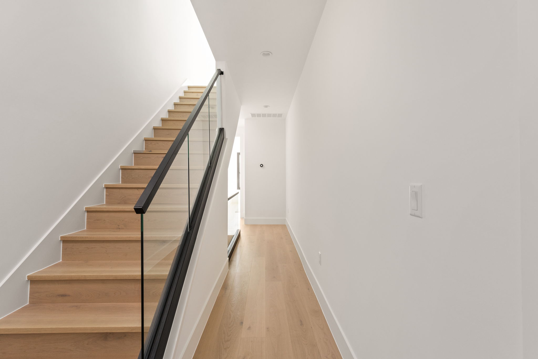 1610 Harvey Street, Unit 2 Austin, TX 78702 - Photo 13 of 38 Staircase featuring wood finished floors and baseboards