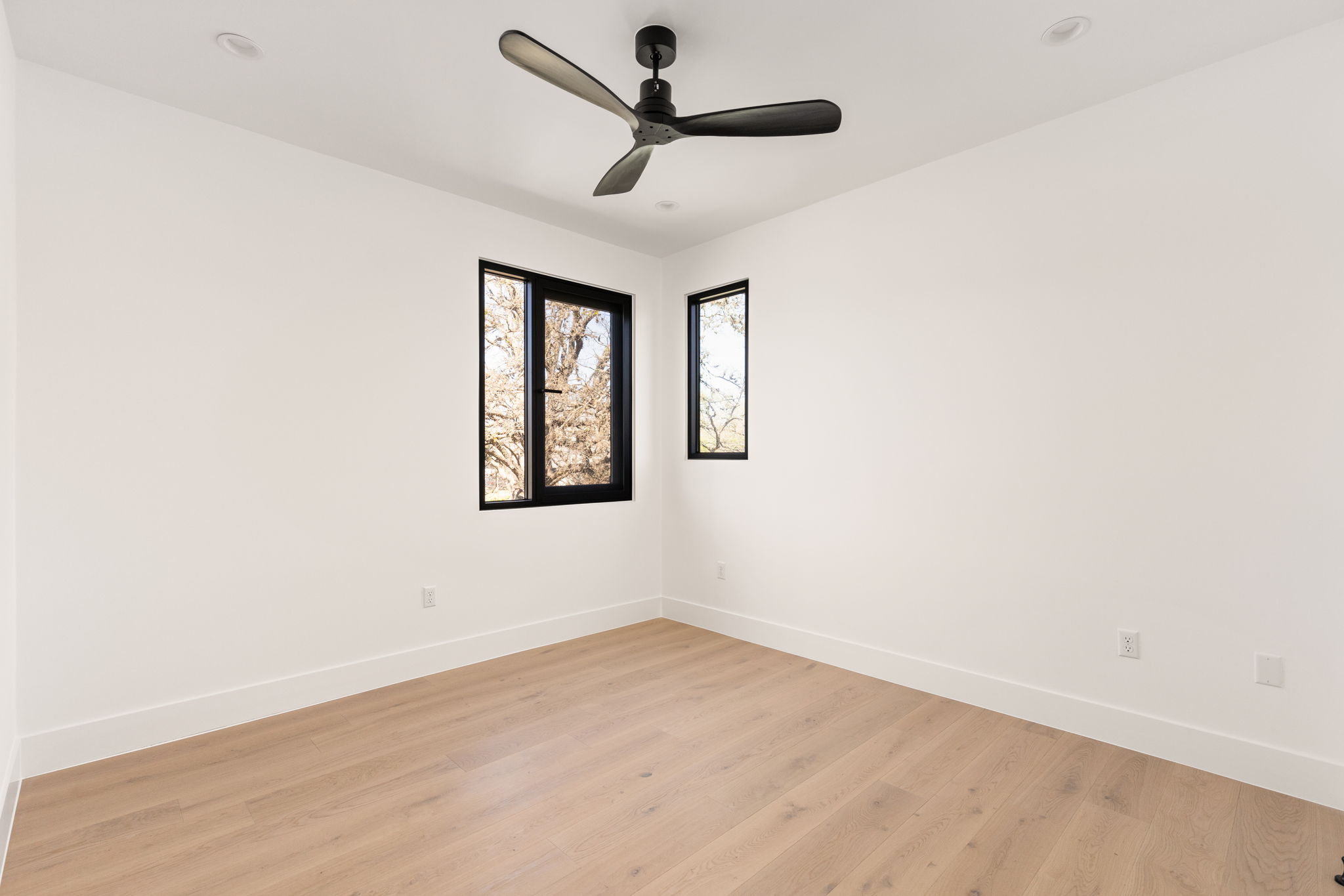 1610 Harvey Street, Unit 2 Austin, TX 78702 - Photo 21 of 38 Empty room featuring light wood-type flooring and a ceiling fan
